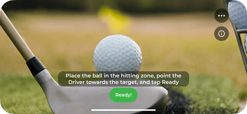 Camera view of a ball next to a driver head with the prompt to place the ball in the hitting zone, point the driver towards the target and tap Ready